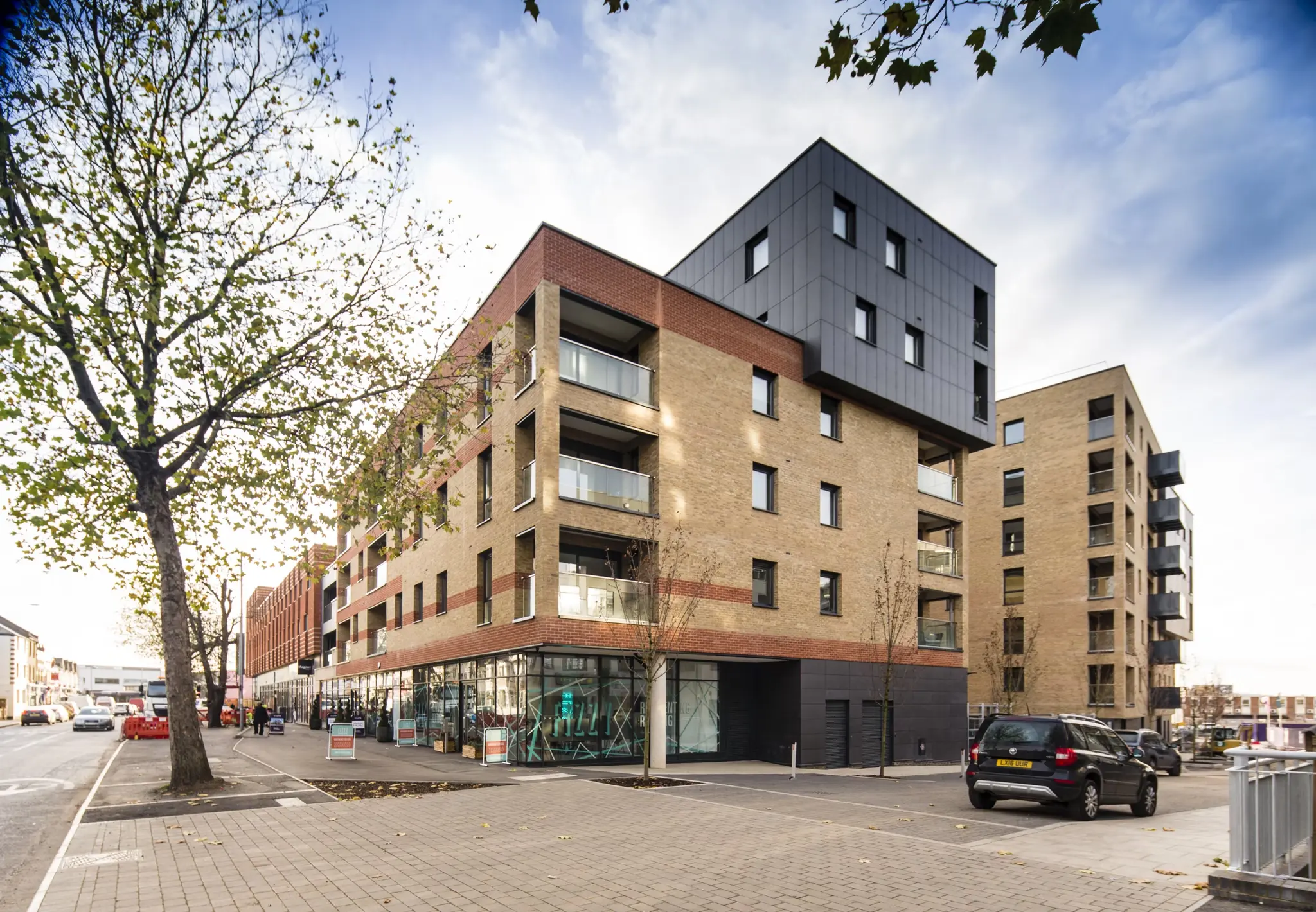 Fizzy Walthamstow exterior view showing modern brick building with balconies and ground-floor entrance from the street