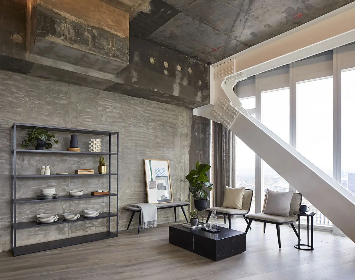 Thumbnail Industrial-style loft interior at Manhattan Loft Gardens with exposed concrete and floor-to-ceiling windows