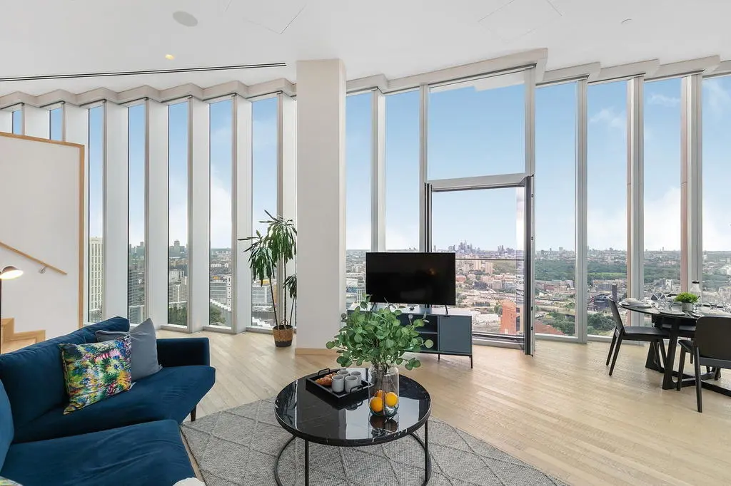 Thumbnail Luxury apartment living area at Manhattan Loft Gardens with floor-to-ceiling windows and panoramic city views