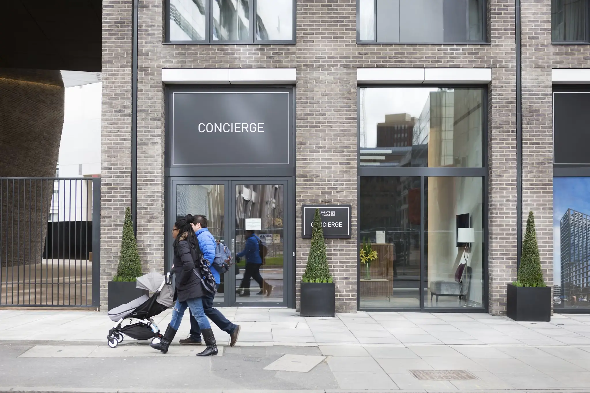 Street view of MyLo Aldgate Place with concierge entrance and modern brick facade