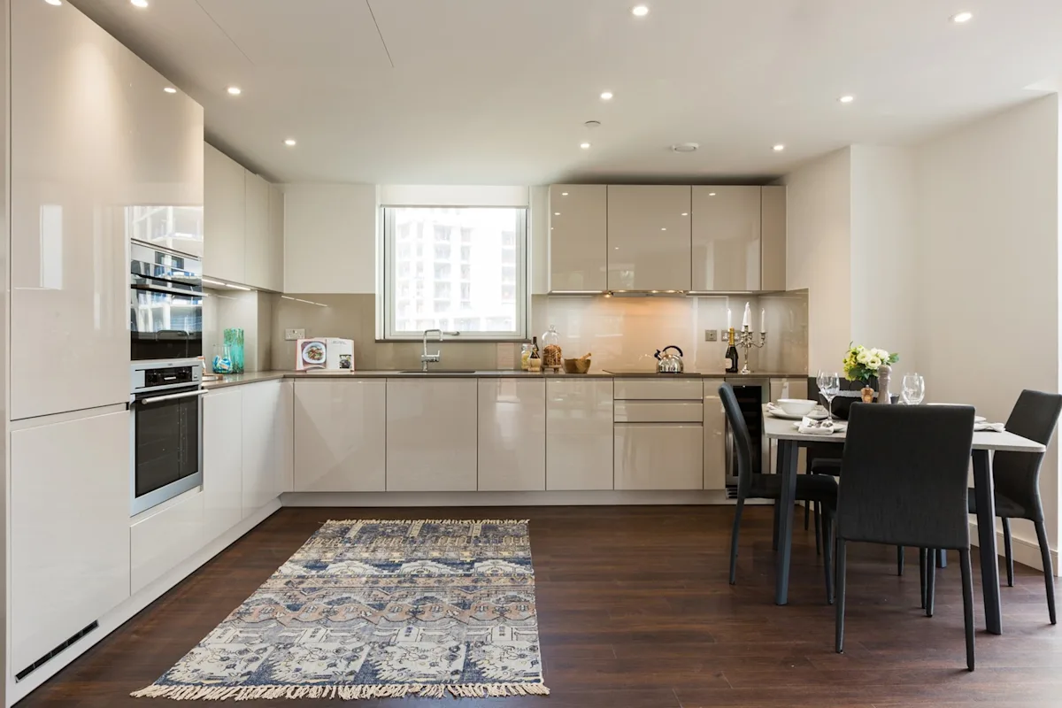 Thumbnail Sleek kitchen with integrated appliances and dining space at MyLo Nine Elms Point