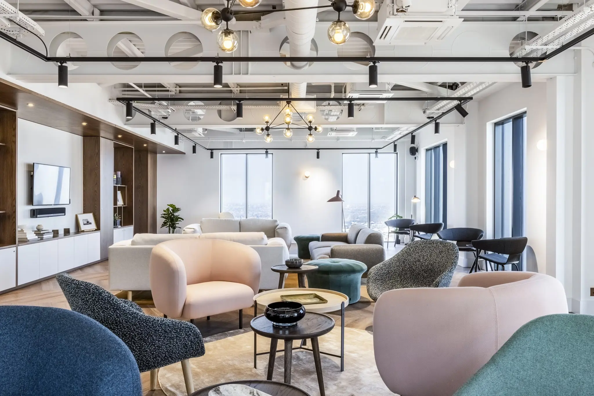 Thumbnail Bright communal lounge at Ten Degrees with modern seating, large windows, and industrial-style ceiling