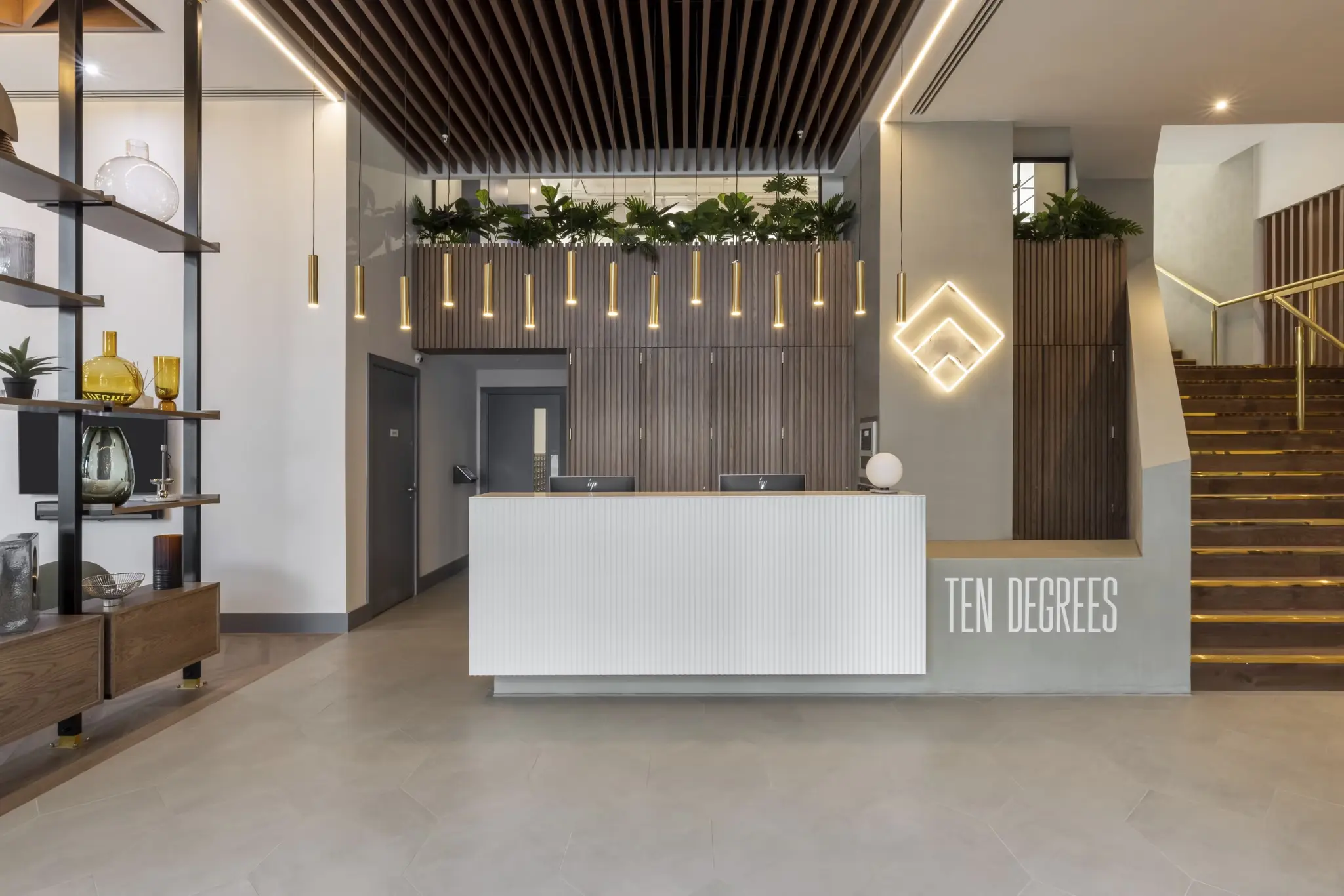 Thumbnail Ten Degrees lobby with modern reception desk, geometric lighting, and wooden ceiling slats