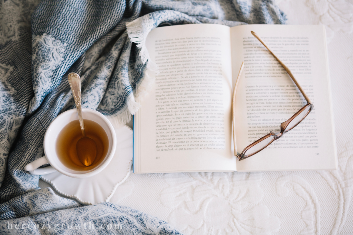 Stack of healing books that feel like therapy with tea and a journal