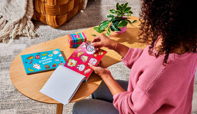 Custom Sticker Books featuring peelable pages for brands and artists