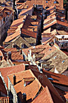 color photograph of red tile roofs and chimneys