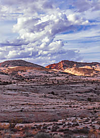 Landscape photograph of rolling hills and storm clouds and blue sky