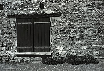Black and white photograph of old doorway on old stone house