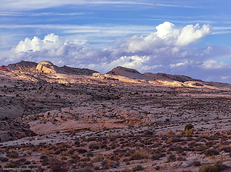 landscape photograph of rolling hills and storm clouds and blue sky