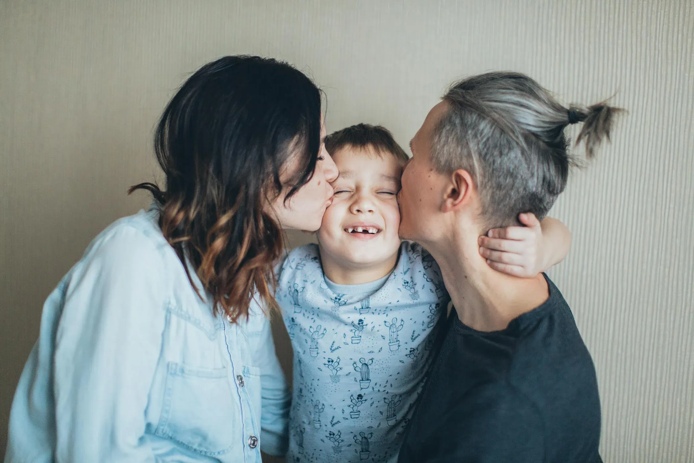 family kissing child