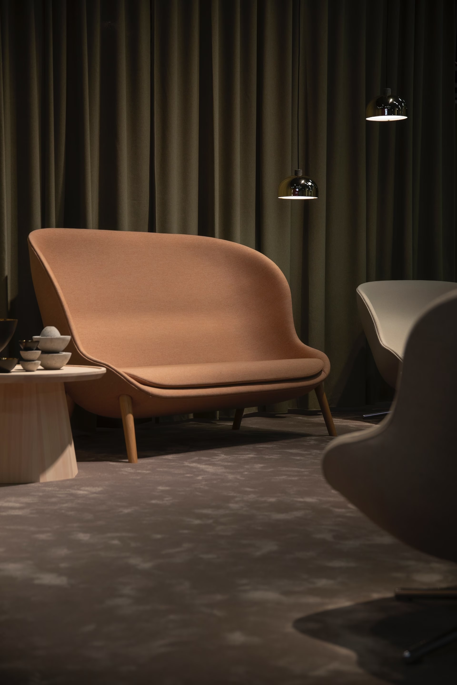 A room with a sofa, chairs, and a table