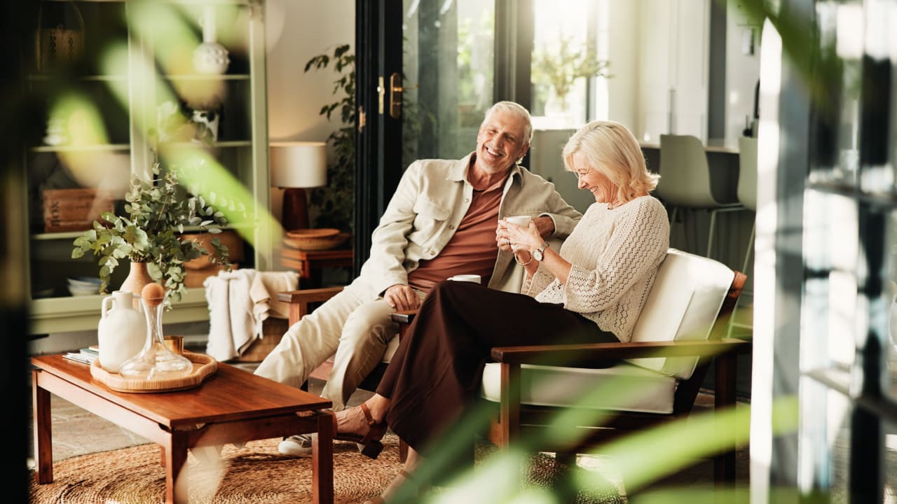 Retired couple relaxing together in a sunlit living room