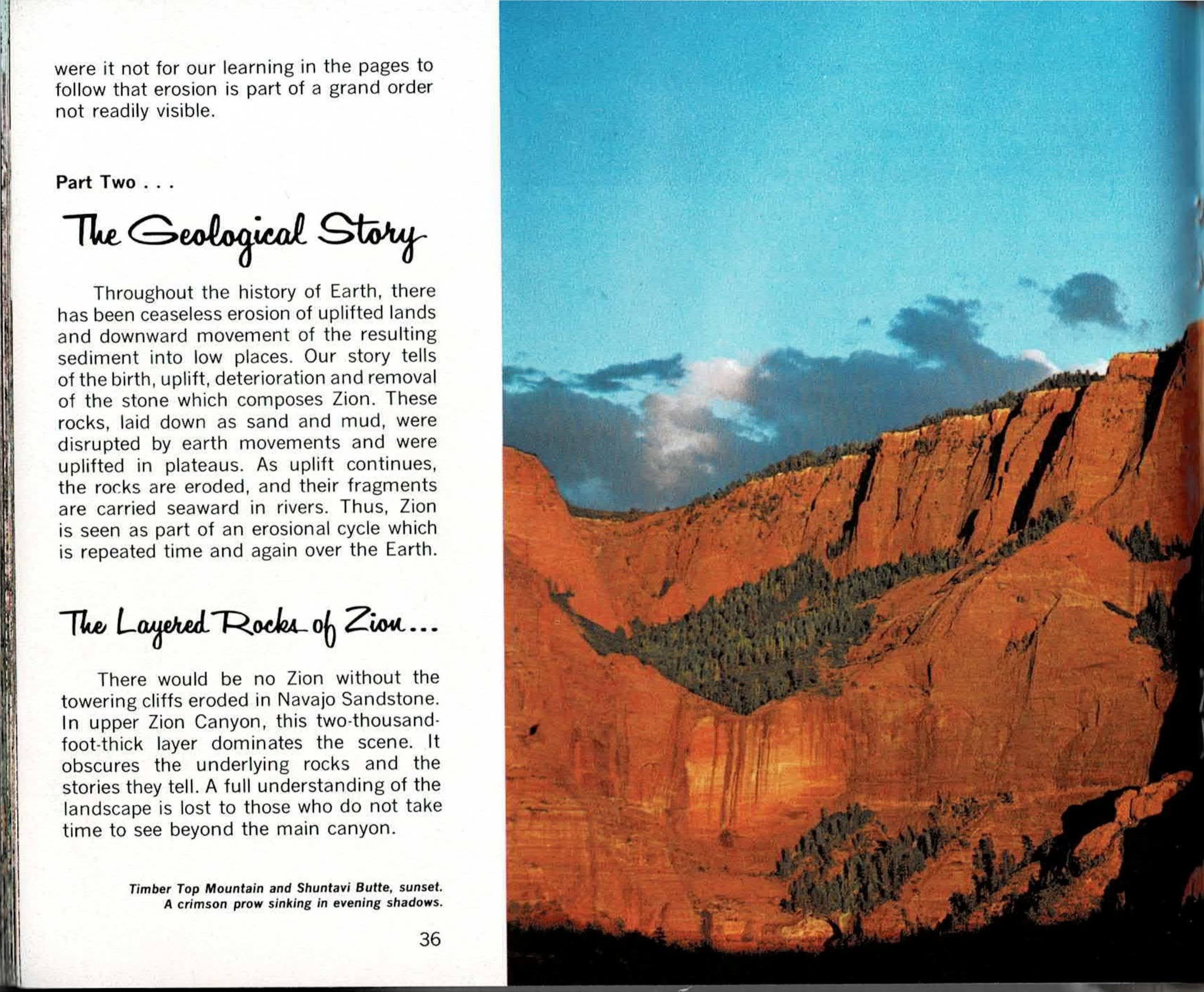 Sunset panorama of tall red sandstone cliffs with a tree-filled notch cutting down the rock face and a pointed butte at right, under a blue sky with scattered clouds, spanning across the printed spread.