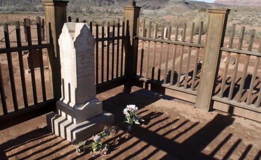 Grafton cemetery wooden fence enclosure with tall marble gravestone and red cliffs behind