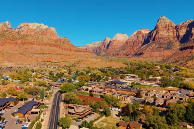 Aerial view of Springdale, Utah below the red cliffs of Zion