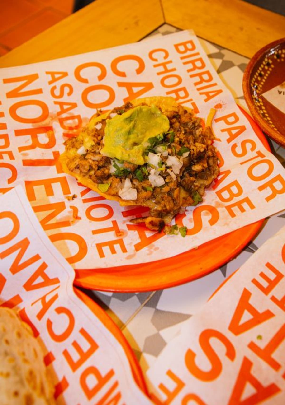 Vegetarian tlayuda with avocado, cheese, and beans, a naturally meat-free Oaxacan dish