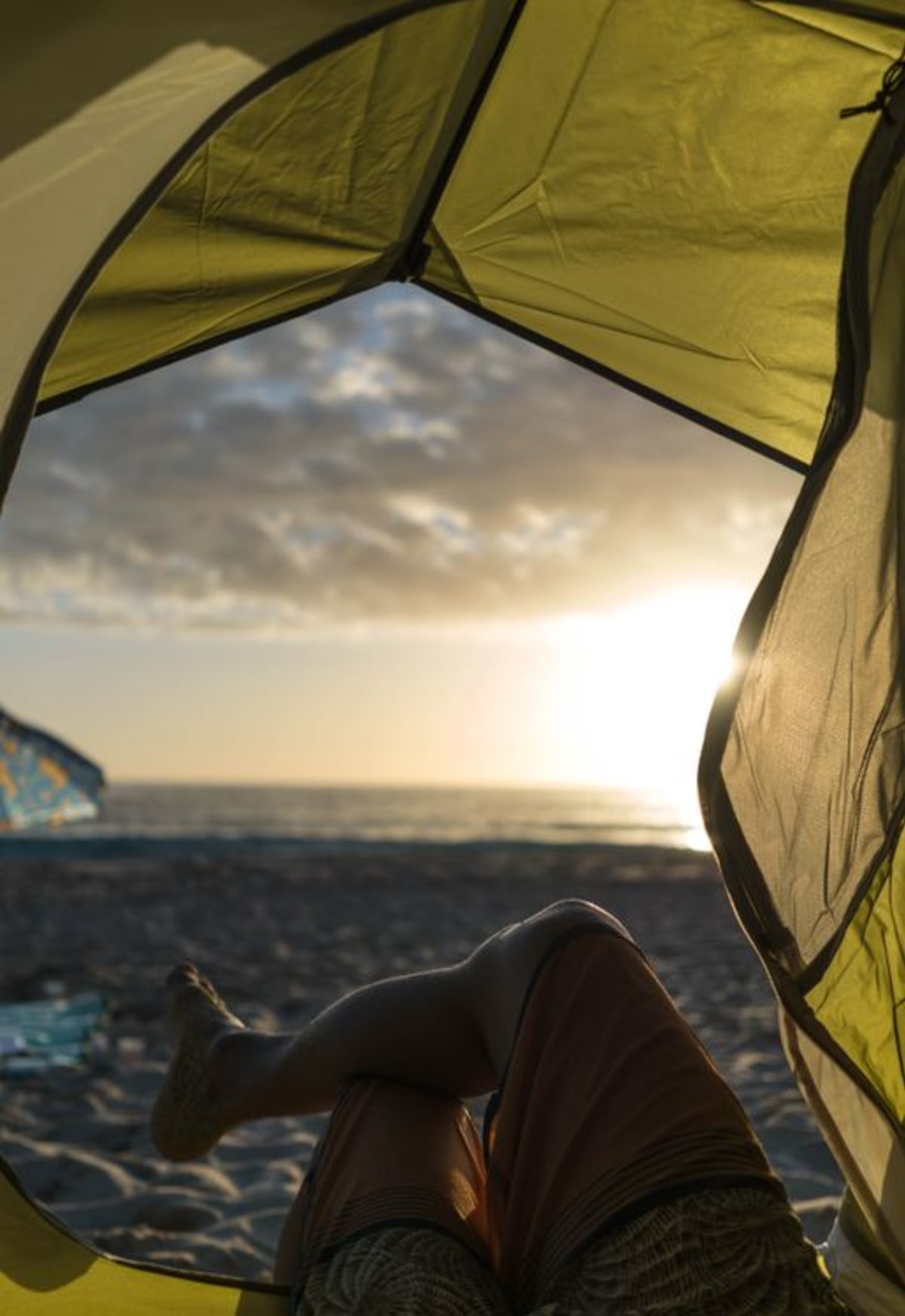 Camping in Puerto Escondido tent pitched on the beach facing the ocean at sunset