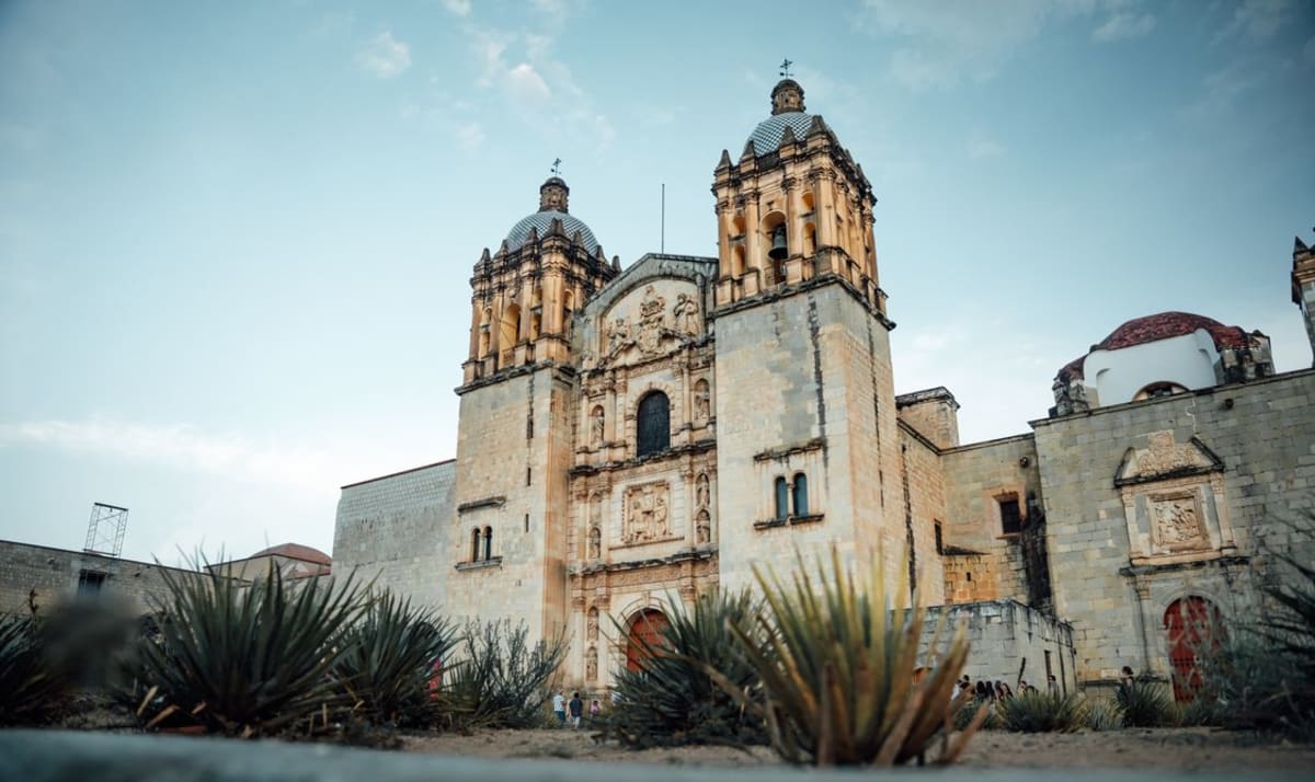 Santo Domingo church in Oaxaca City with agave plants, a highlight of a Oaxaca City and Puerto Escondido itinerary