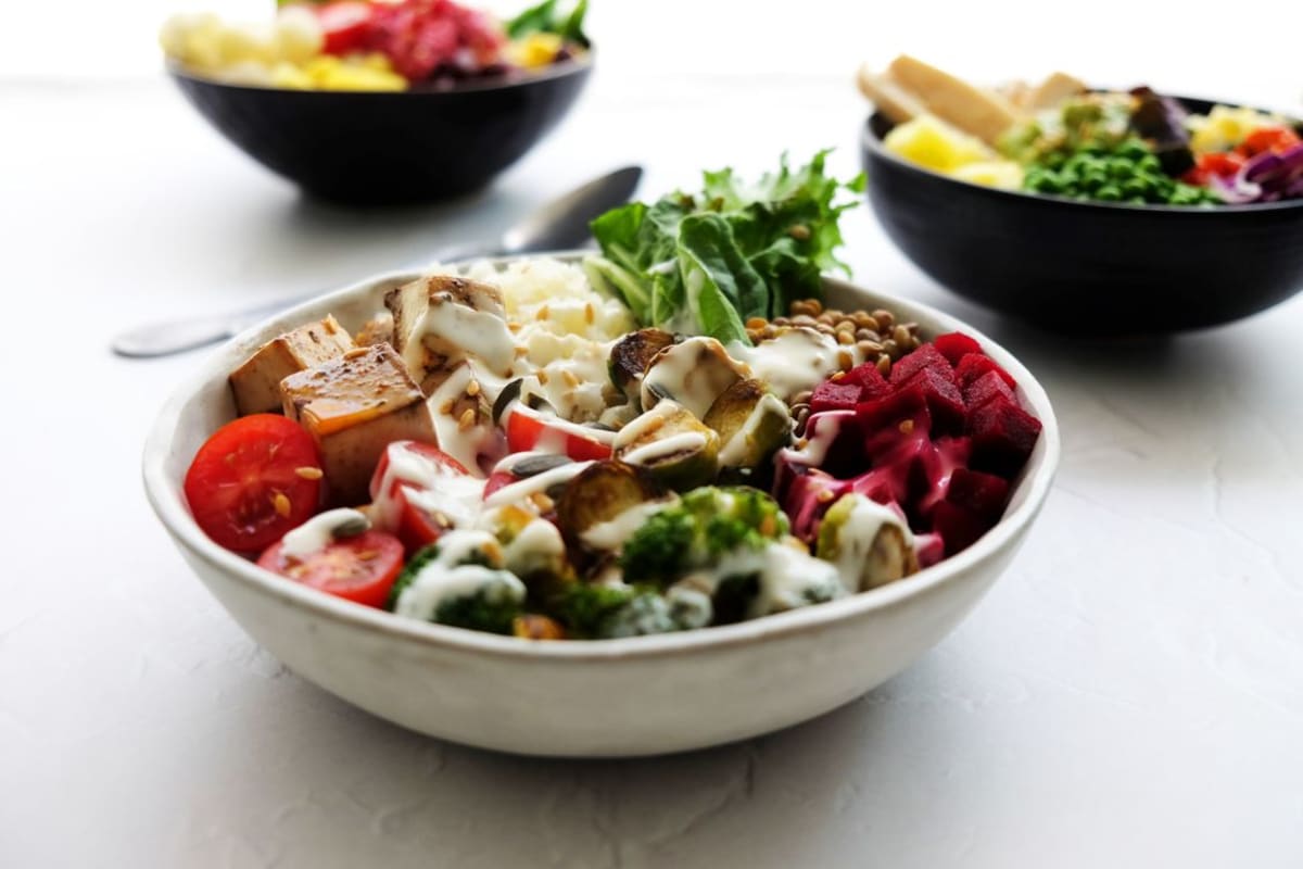 Vibrant vegan Buddha bowl with fresh vegetables at a vegetarian restaurant in Puerto Escondido
