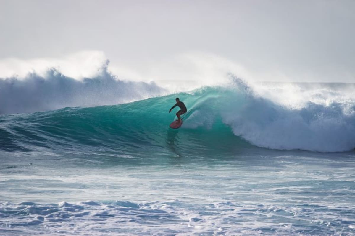 Expert surfer mastering a massive wave on the Pacific coast of Mexico during peak summer surf season