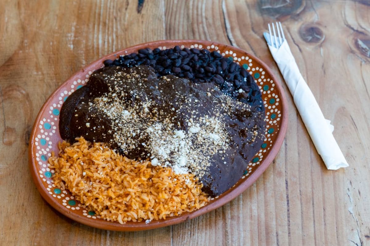 Traditional Oaxacan mole sauce served with rice, a signature dish of Oaxacan cuisine