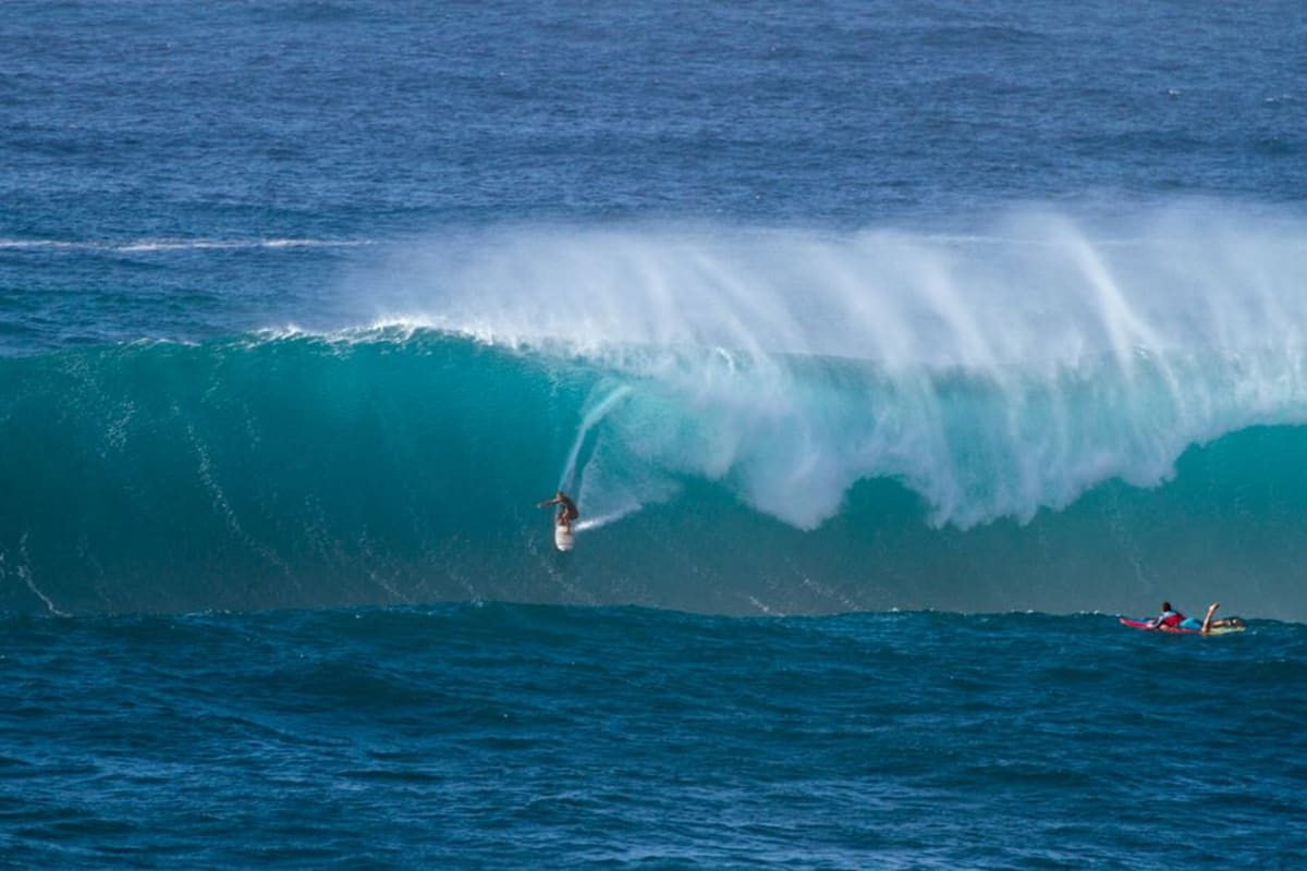 Surfer riding a massive Pacific Ocean wave in Puerto Escondido Mexico during peak July August surf season