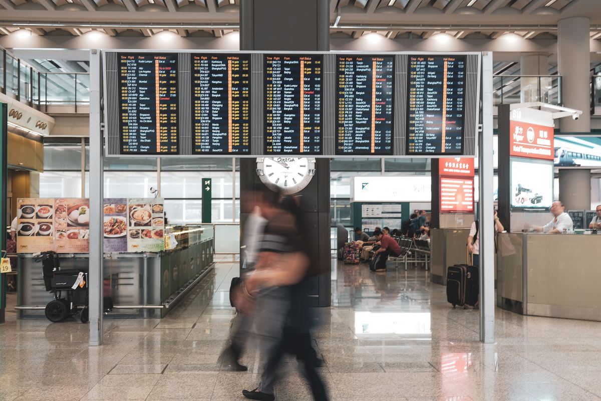 Terminal d'aéroport moderne avec des voyageurs et des écrans d'information