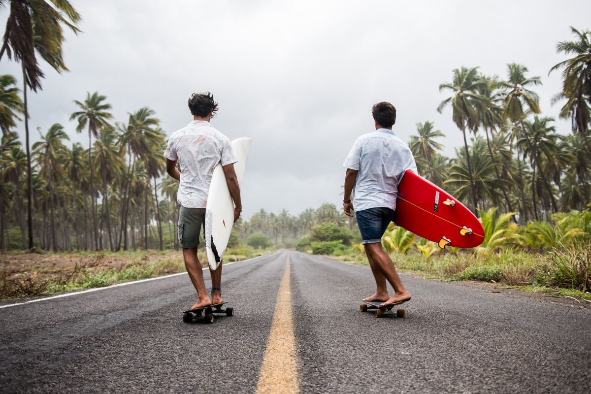 Longboard surfer gracefully riding a long tropical wave in warm clear water