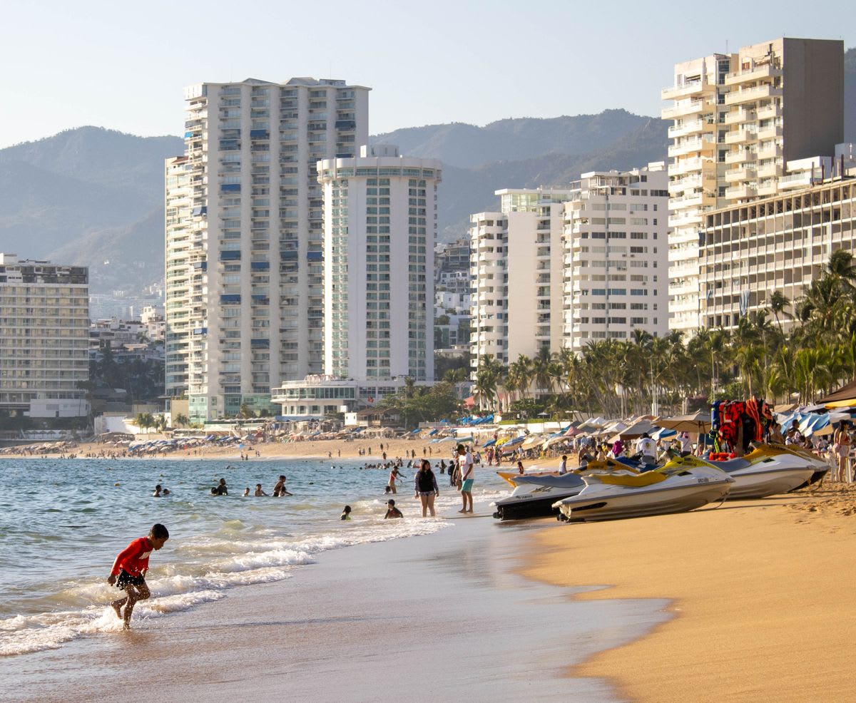 Acapulco beachfront with high-rise hotels and the sweeping bay in the background