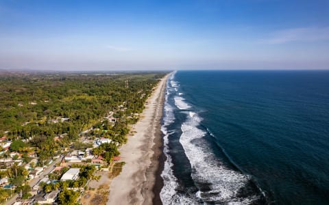 Wild, empty beach stretching into the distance at La Barra de Colotepec