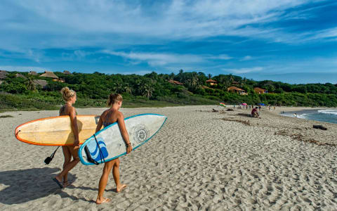 Playa Zicatela at golden hour with surfers and the Pacific in the background, Puerto Escondido