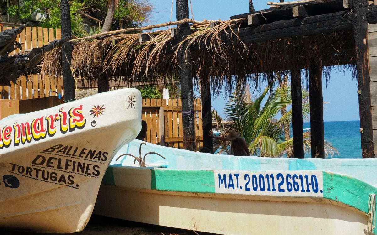 Colourful wooden fishing boats moored in Playa Principal bay at dawn, Puerto Escondido