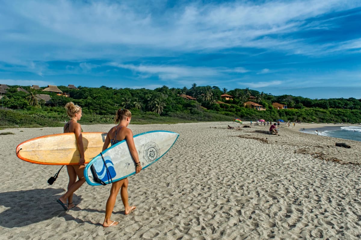 Surfers at golden hour in Puerto Escondido