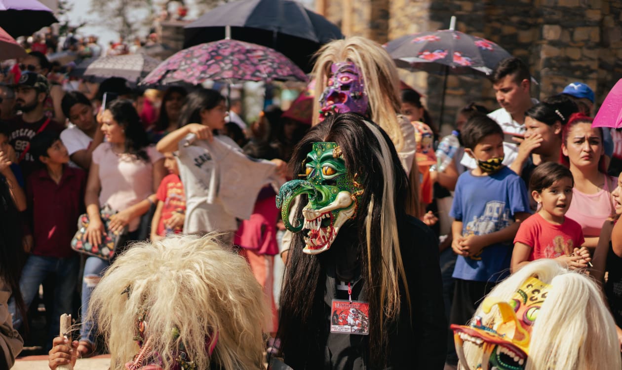 Colorful Mexican festival crowd with traditional masks celebrating in Puerto Escondido during April Semana Santa