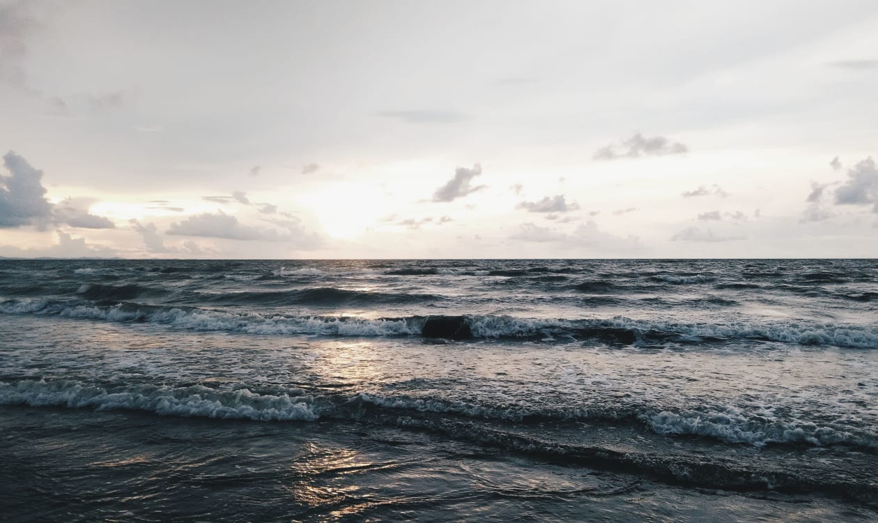 Ocean waves rolling in under an overcast August sky, typical of Puerto Escondido surf season on the Oaxacan coast