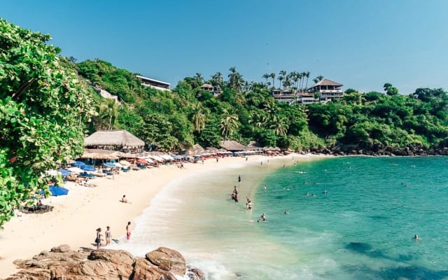 Turquoise cove and sandy beach on the coast near Puerto Escondido seen from above