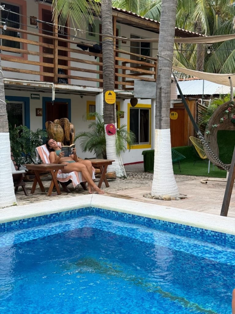 Guest relaxing by the pool at Frida Paradise