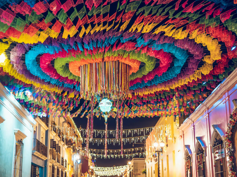 Colorful street decorations during a vibrant festival night in Oaxaca, Mexico