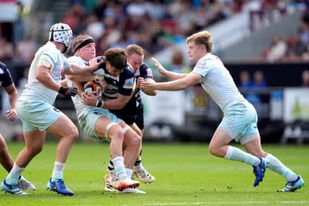 Fin Smith (right) closes in on Bristol Bears’ Benhard Janse van Rensburg