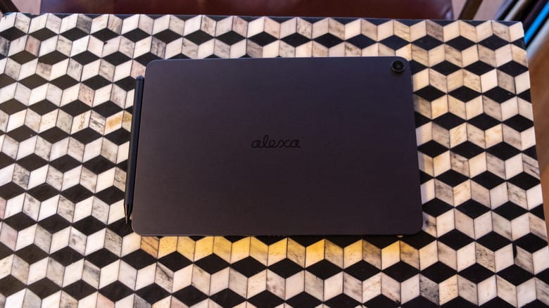 The back of the Alexa Tablet 12 Pro with the option pen accessory sitting on a table.