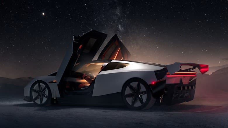 A Tesla Roadster on a desert landscape at night.
