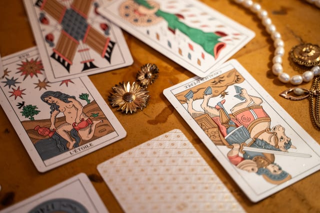 cartes du Tarot de Marseille disposées avec bijoux et objets