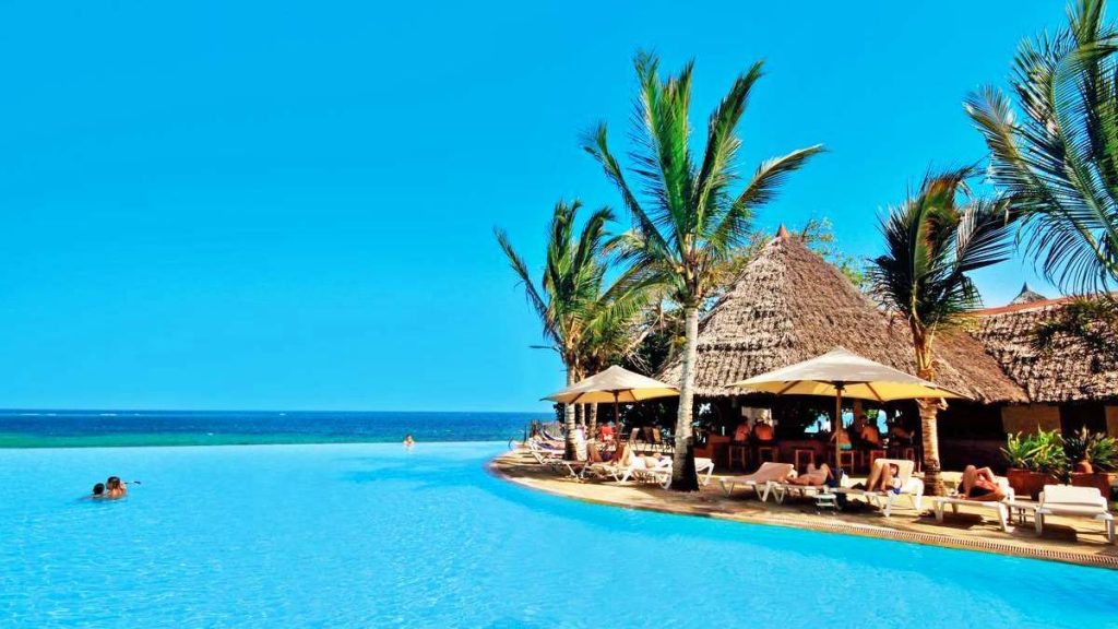 Pristine white sand beach with palm trees and turquoise waters on Kenya's coast