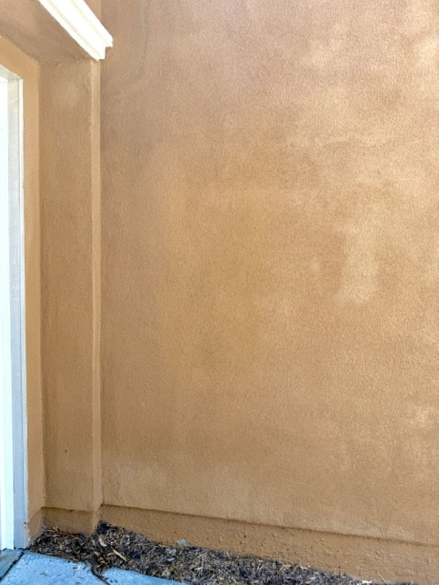 Stucco wall after soft washing, clean and streak-free