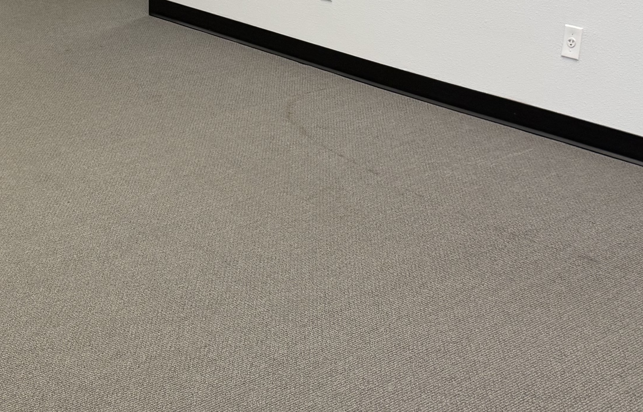 Lobby carpet with stains before cleaning