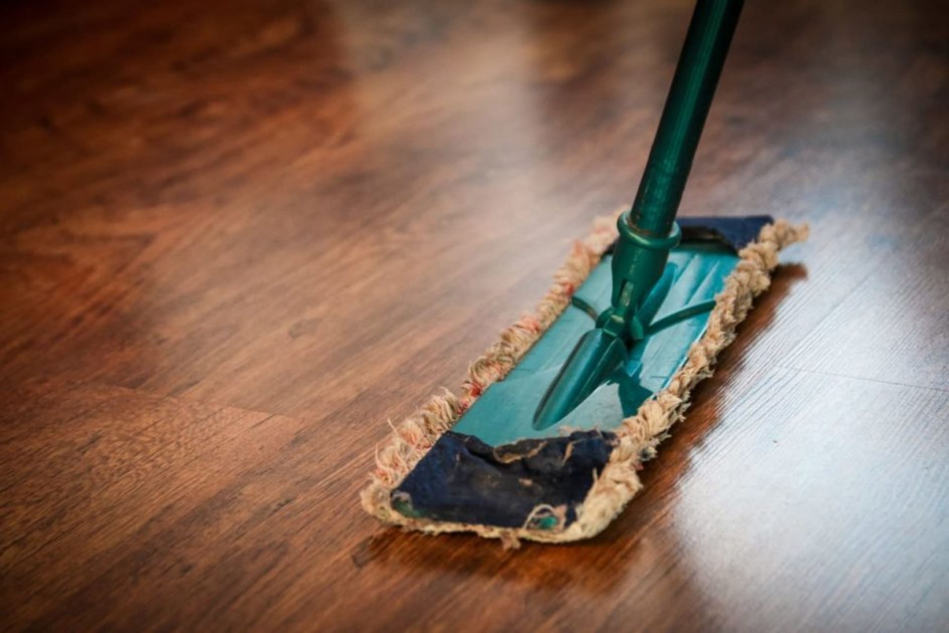 Team member wiping a conference table surface during cleaning service