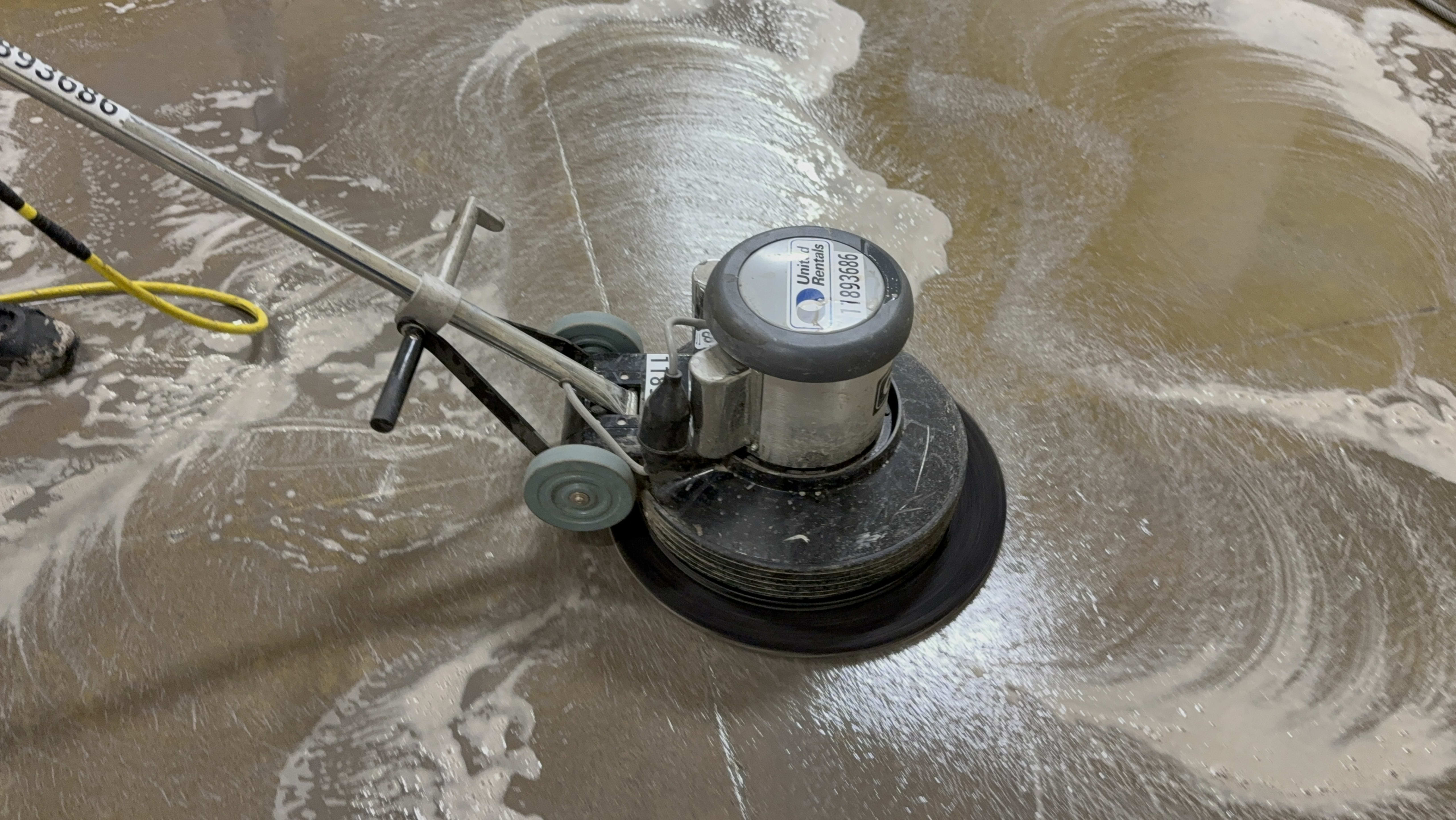 Floor buffing machine in use on a commercial floor