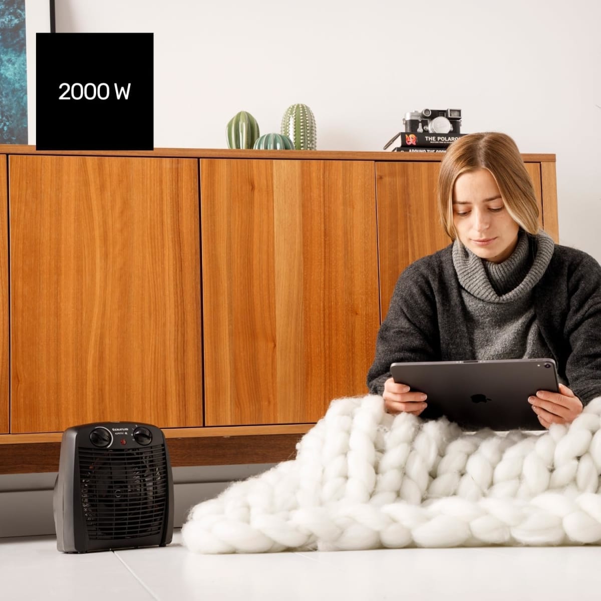 Mujer usando tablet con calefactor Taurus 2000W