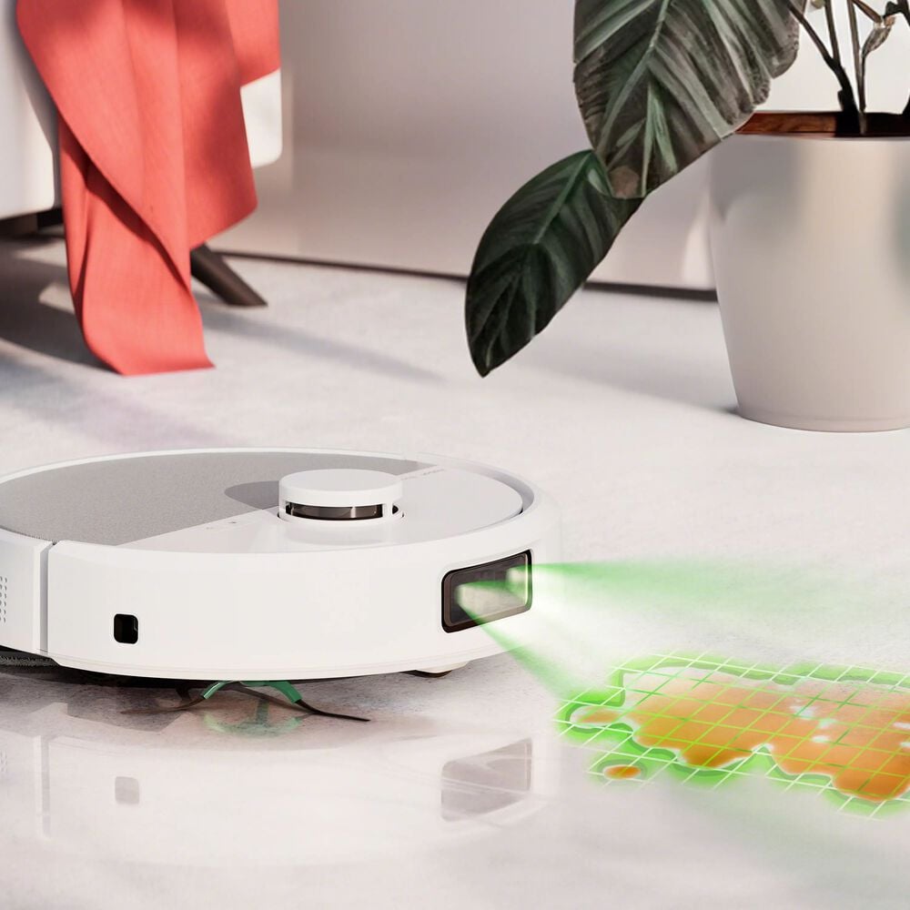 Robot aspirador en funcionamiento con luz verde mapeando el suelo