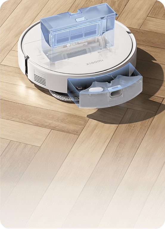 Robot aspirador Xiaomi blanco con depósitos de agua extraíbles sobre suelo de madera.